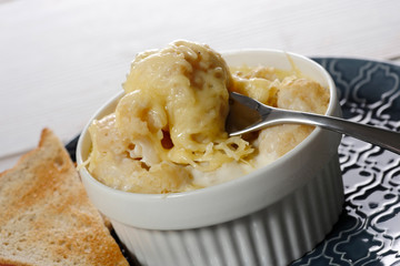 cauliflower gratin with cheese in  blue plate
