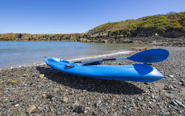 Blue kayak on Anglesey beach,North Wales Uk,beautiful weather and blue sky  in spring.