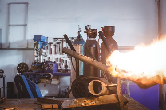 Hand of male welder holding welding torch
