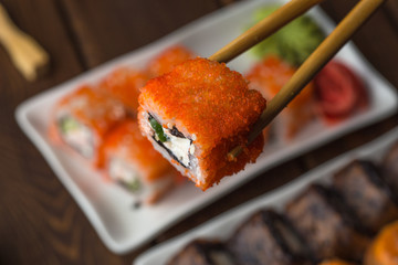 Sushi-roll set and bamboo sticks with roll,, selective focus, Japanese seafood