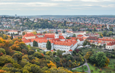 Fototapeta na wymiar Prague, Czech Republic - October 10, 2017: Bright and beautiful autumn view on Prague Castle, Old town and city center with old red roofs, Prague, Czech Republic