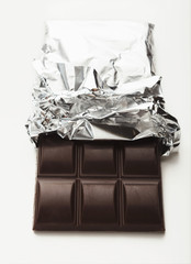 Bar of dark chocolate isolated on white