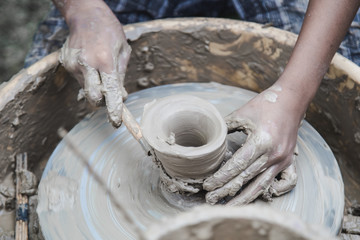 Closed up hands man using mechanic pottery made earthenware.