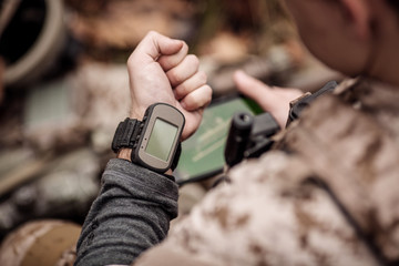soldiers holding gps in hand and determines the location of coordinates.