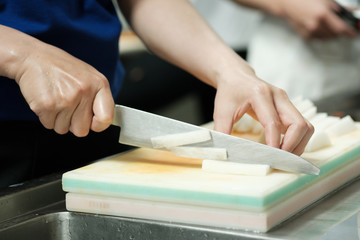 Chef cut vegetable on cutting board with knife japan,slicing radish