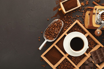 Top view on scattered coffee beans and spices, background with c
