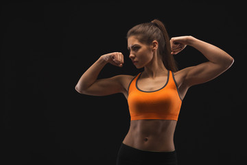 Fototapeta na wymiar Athletic woman showing muscular body