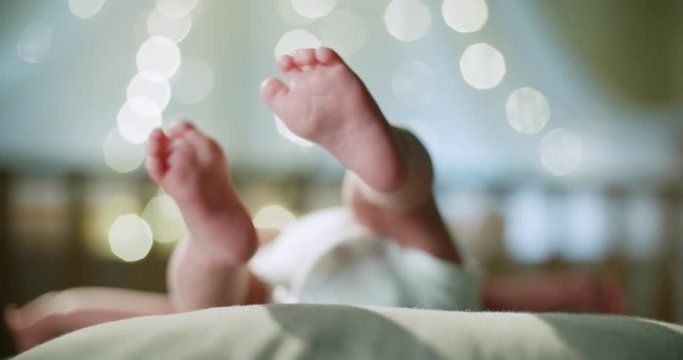 4k, newborn baby's legs close-up, High-key shot slow motion beautiful bokeh background