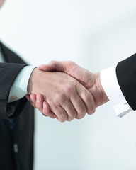 closeup of a business handshake partners. the image is blurred.