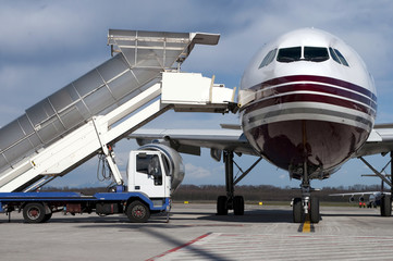 airports boarding ladder next to plane, front view

