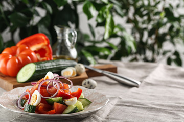 fresh vegetable salad with quail eggs in pink plate on the table
