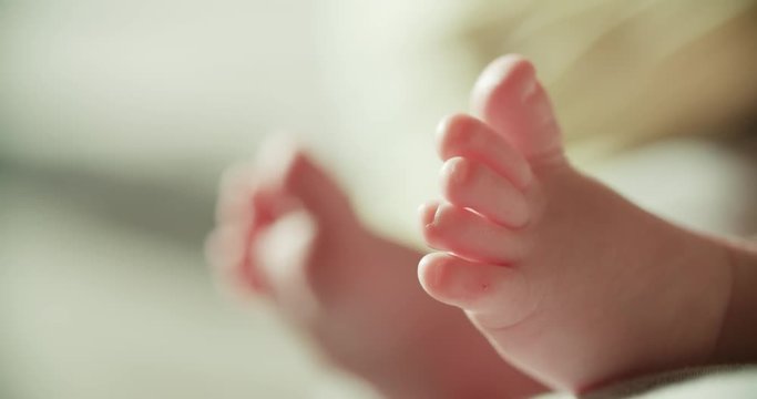 4k, newborn baby's legs close-up, High-key shot slow motion