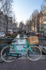 bicycle leaning on a bridge railing in Amsterdam, Netherlands