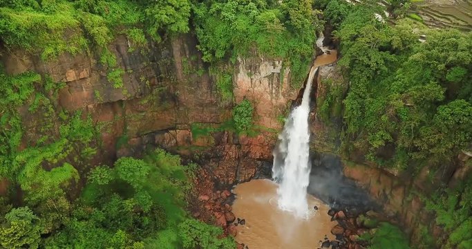 Exotic aerial scenery of Cimarinjung waterfall from a drone flying at Ciletuh Geopark, Sukabumi, West Java, Indonesia. Shot in 4k resolution