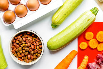 healthy dogfood with eggs, vegetables and meat on kitchen backgr