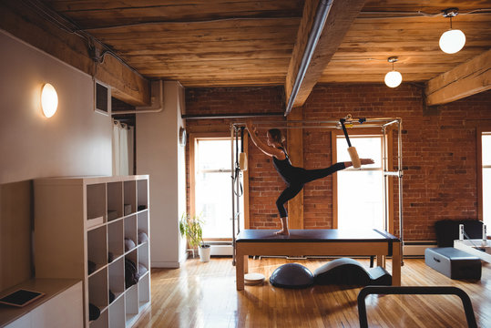 Woman practicing pilates in fitness studio