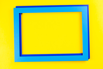 Blue color frame on bright yellow background.