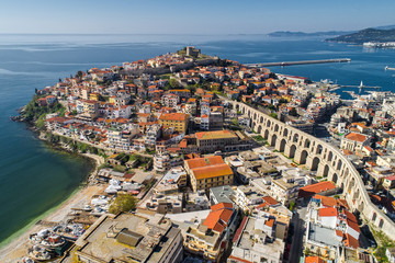 Aerial view the city of Kavala in northern Greek, ancient aqueduct Kamares, homes and medieval city wall