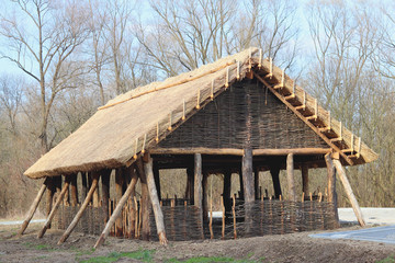 Fototapeta na wymiar Reconstruction of the wooden structure, which served as a lodging house for the early peoples of central Europe. Architectural structure. The engineering thought of our ancestors. 