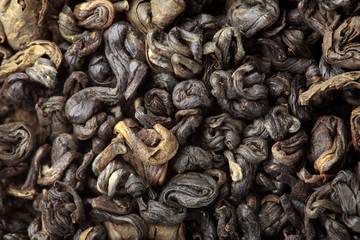 Green tea texture.Closeup.Macro shot.Pile of dry green tea.