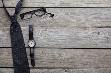 Set of stylish men on rustic wood background, top view