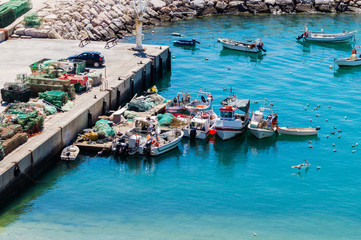 Fototapeta na wymiar Aerial view of fihsing boats in the Porto de Abrigo de Albufeira, Albufeira Bay in Albufeira, Portugal