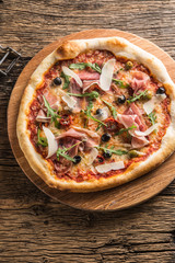 Top of wiew italian pizza on wooden plate and round board