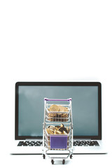 Laptop and Shopping cart full of Taiwan Coin