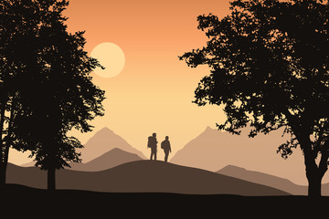 Two tourists with backpacks in mountain landscape with deciduous forest, under orange sky with sun