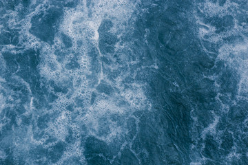 Fototapeta premium Abstract blue sea water with white foam and bubbles for background, natural summer background, pattern concept