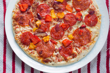 Salami and pepperoni pizza with red yellow peppers 