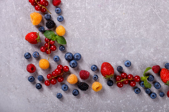 Various fresh summer Berries on the Gray Background.Mix Berries.Food or Healthy diet concept.Super Food.Vegetarian.Top View.Copy space for Text.selective focus.