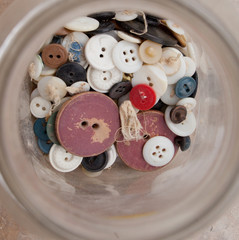 Collection of old antique buttons in a glass jar