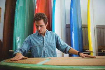 Man making surfboard in workshop