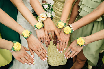 hands of the bride and bridesmaids