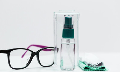 Glasses, napkins, liquid in a bottle, white background