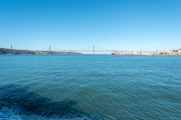 Obraz premium View over Tagus river and the 25th April Bridge in Lisbon, Portugal