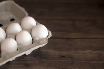 Farm Fresh White Chicken Eggs on a Dark Wood Table