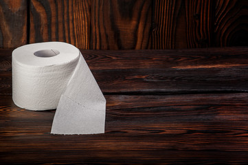 toilet paper on wooden background
