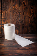 toilet paper on wooden background