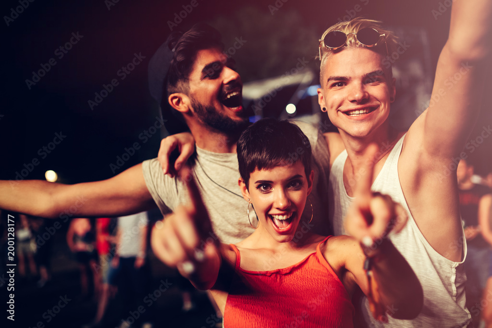 Wall mural happy friends having fun at music festival