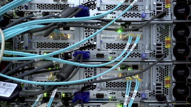 MOSCOW, RUSSIA - April 8, 2018: Modern network switch with cables. Optical severs computer in a rack at the large data center. 4K. April 8. Editorial