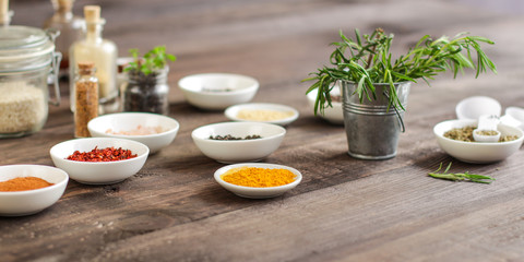 Spices and herbs. Variety of spices and herbs on a wooden surface