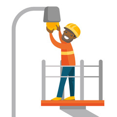 African-american electrician in hard hat working on lamp post and repairing broken light bulb. Electrician changing light bulb. Vector cartoon illustration isolated on white background. Square layout.