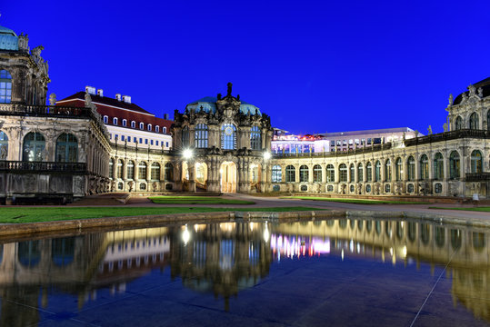 Panorama of Dresden Zwinger Palace in Rococo style at night with reflection in water bassin, Dresden, Saxony, Eastern Germany