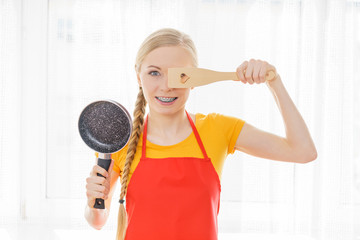 Woman holding cooking utensils