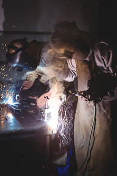 Welders welding a metal
