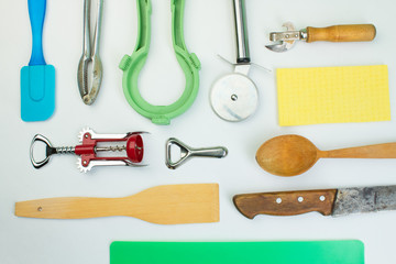 Background of kitchen utensils on white wooden kitchen table. tools. Top view.