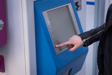 Woman using ticket vending machine at station
