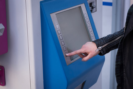 Woman using ticket vending machine at station